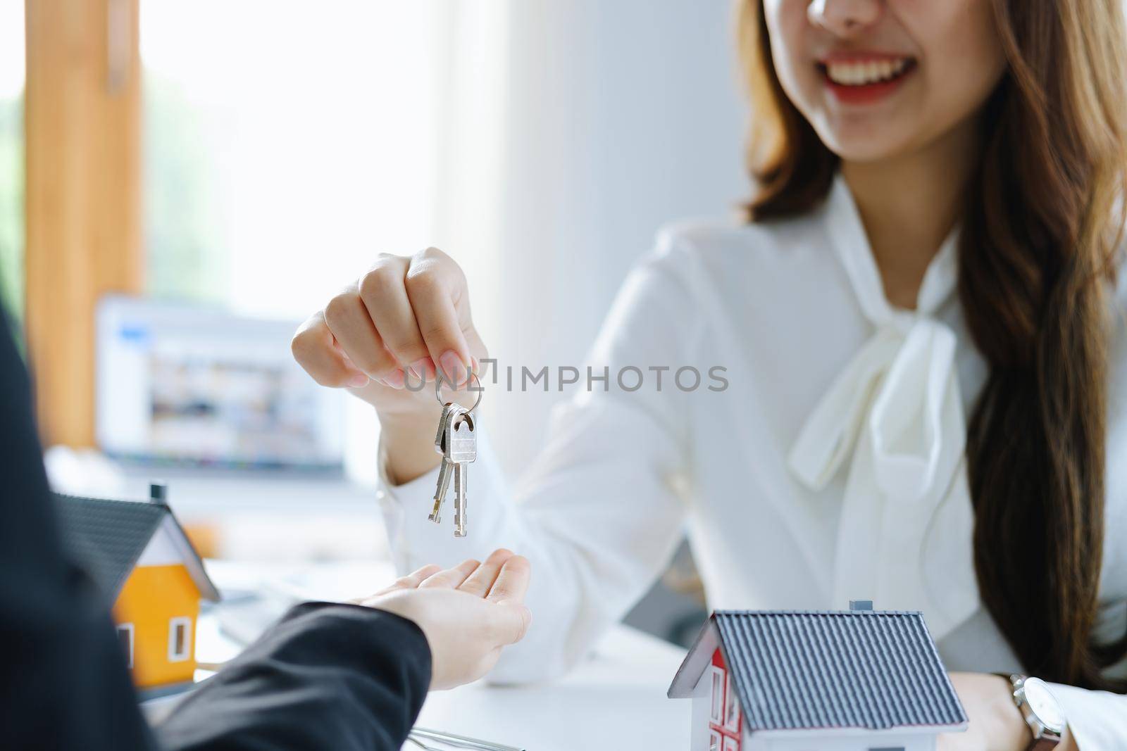 Guarantee, mortgage, agreement, contract, sign, real estate agent delivers the keys to the customer after signing important contract documents by Manastrong