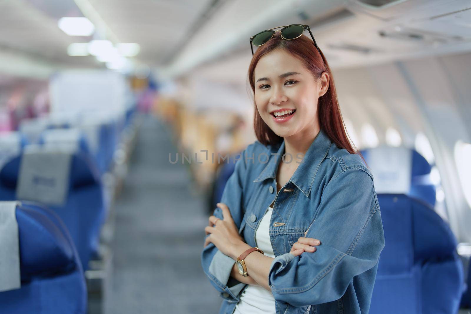 travel business Portrait of an Asian woman showing joy while waiting for a flight by Manastrong