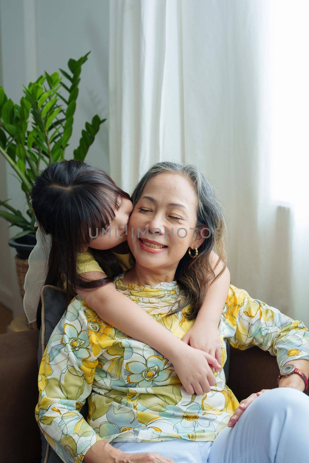 Asian portrait, grandma and granddaughter doing leisure activities and hugging to show their love and care for each other.