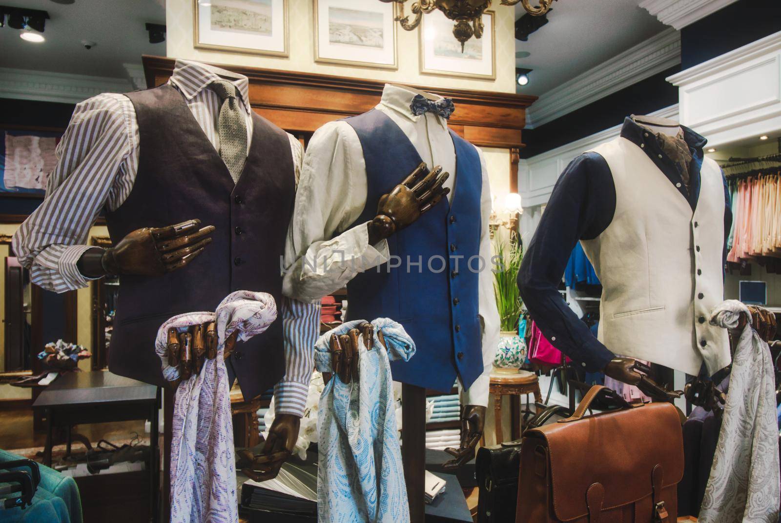 Wooden mannequin display showing men's clothes in a high-end fashion shop