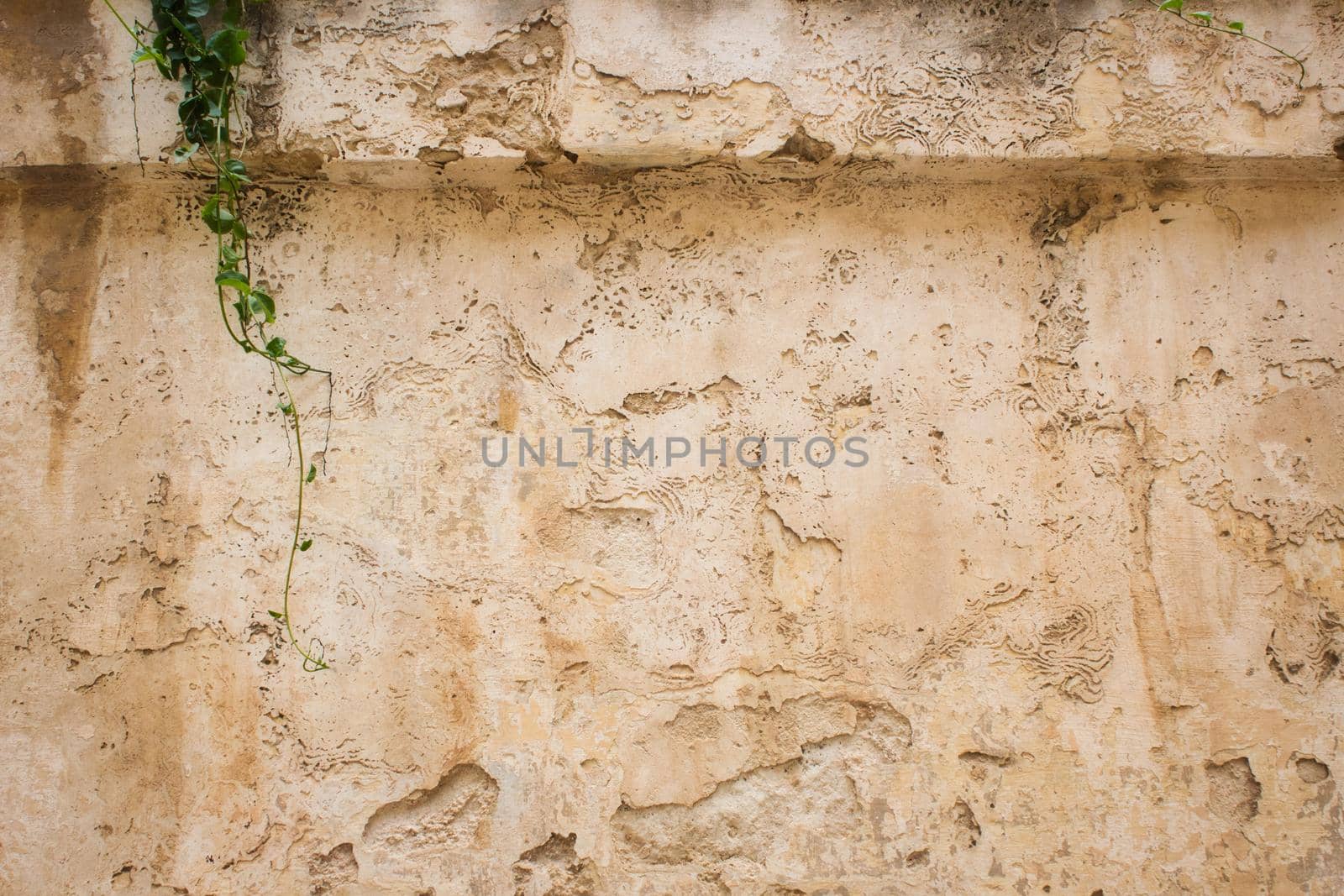 Old weathered stone and plaster wall background