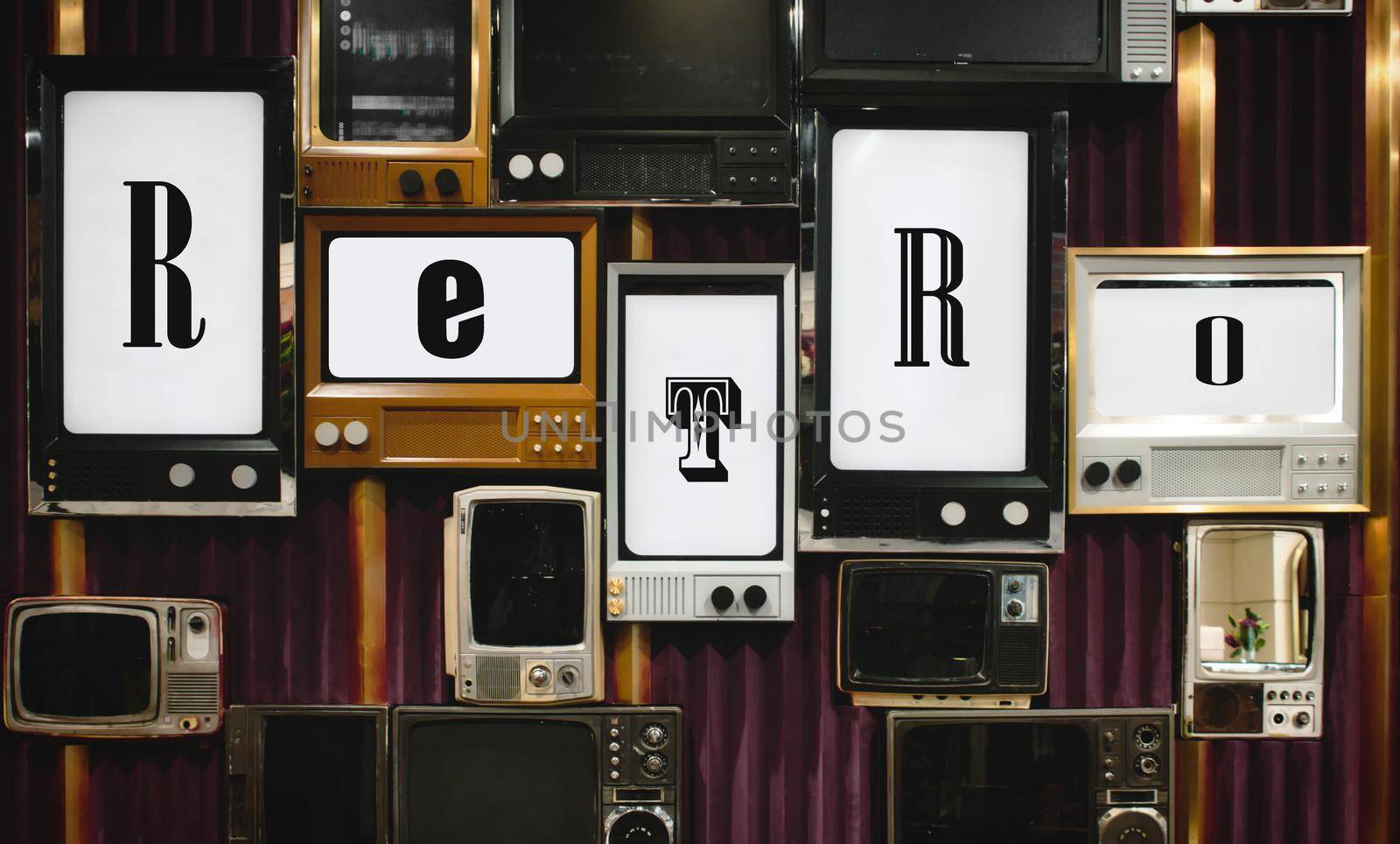 Wall mounted old-fashioned vintage tv screens displaying letters forming the word retro by tennesseewitney