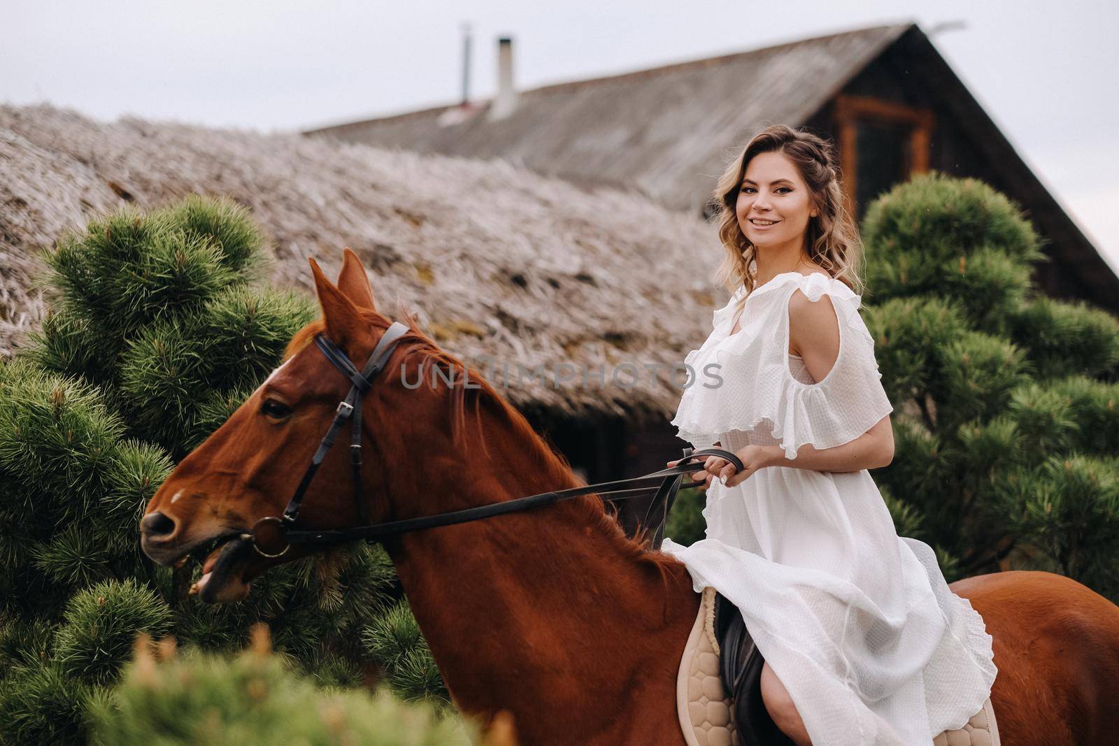 A woman in a white sundress riding a horse near a farm by Lobachad