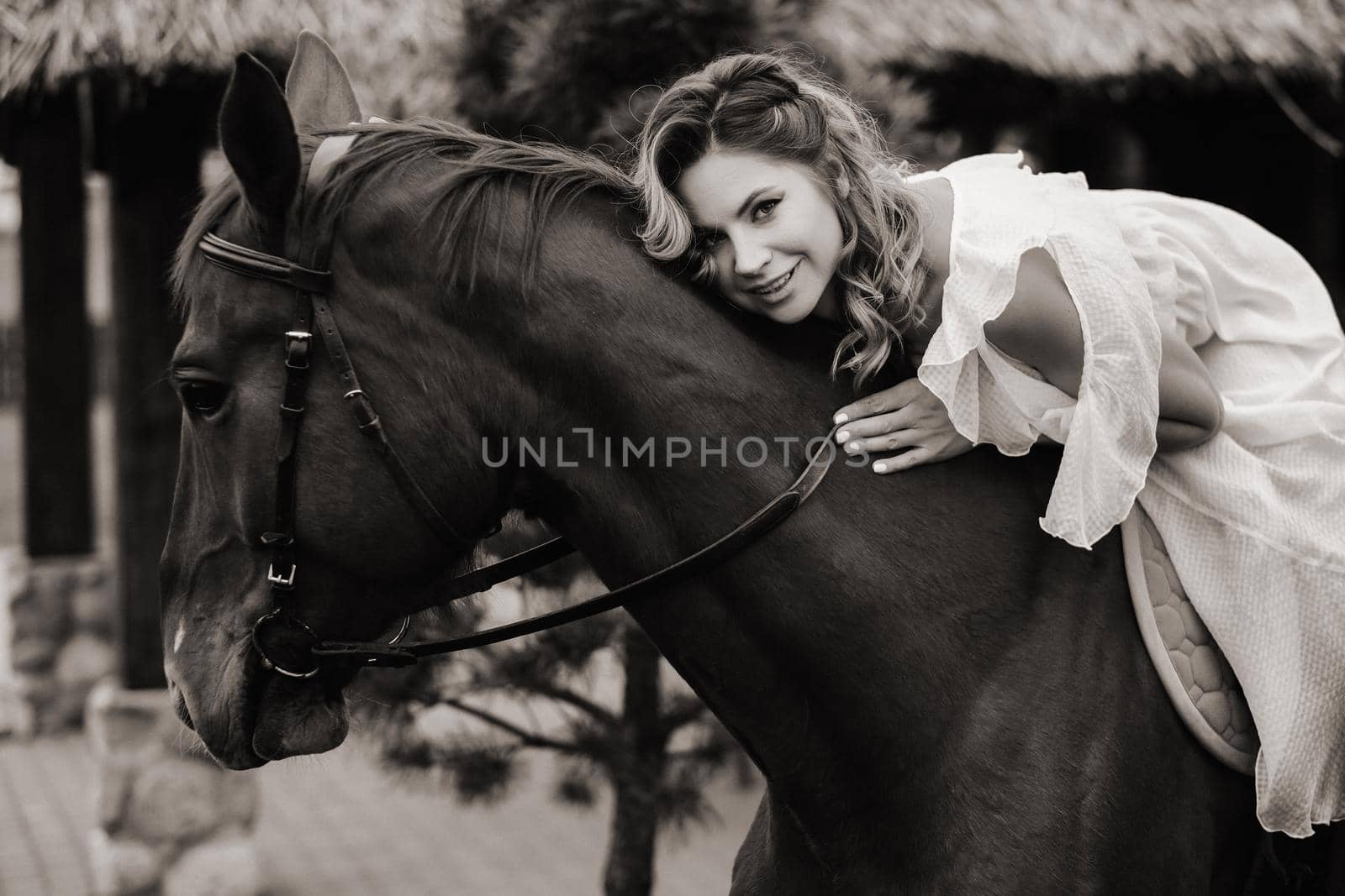 A woman in a white sundress riding a horse near a farm. black and white photo by Lobachad