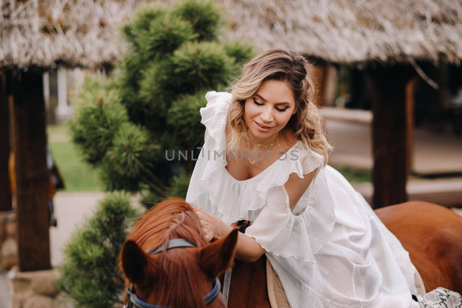 A woman in a white sundress riding a horse near a farm by Lobachad