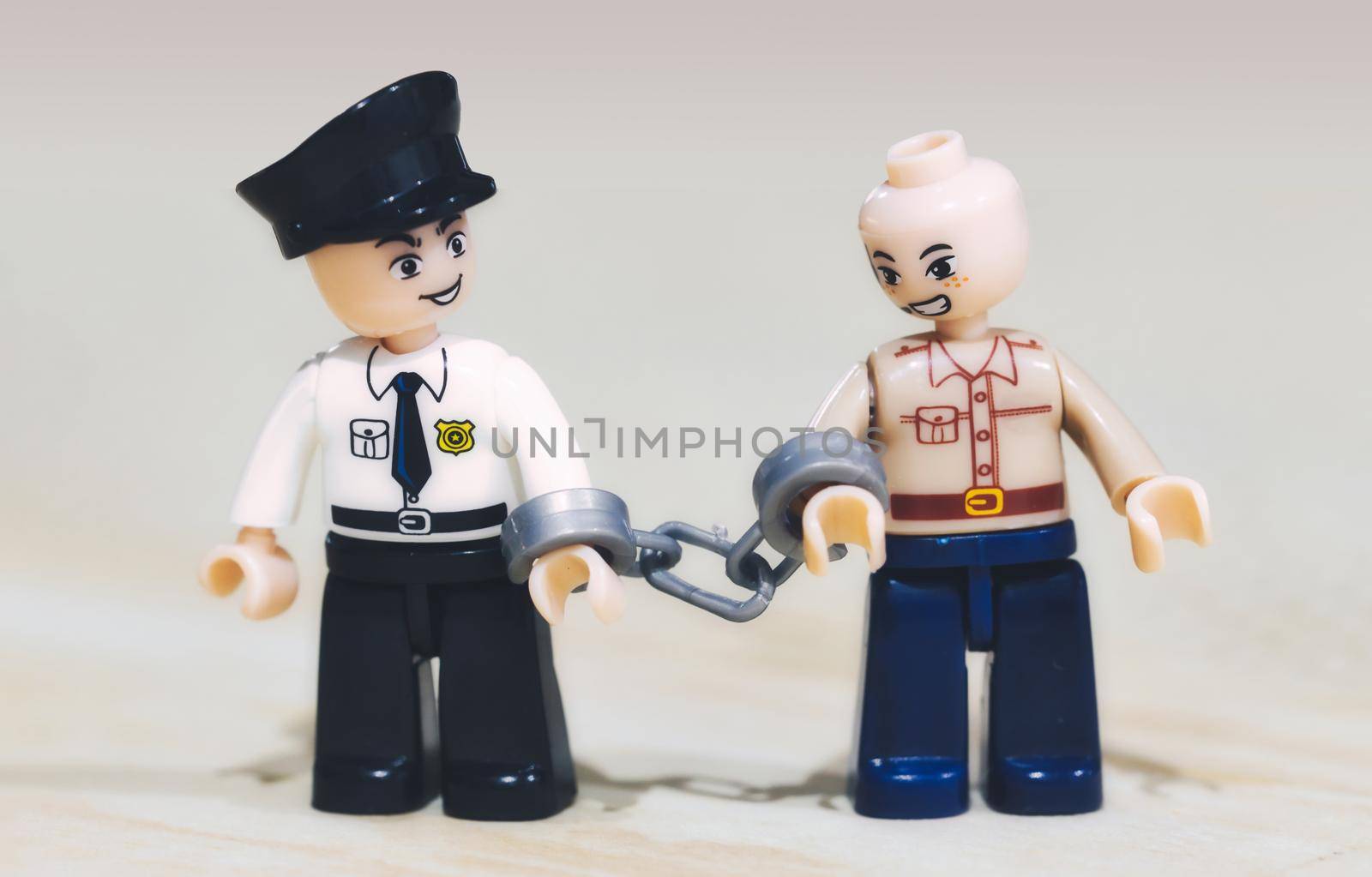 London / UK - April 02 2020: Toy miniature figures: a criminal being arrested by a policeman