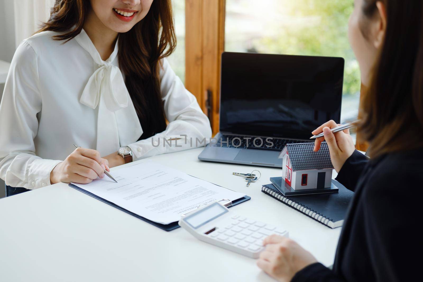 Guarantee, Mortgage, agreement, contract, Signing, Male client holding pen to reading agreement document to sign land loan with real estate agent or bank officer. by Manastrong