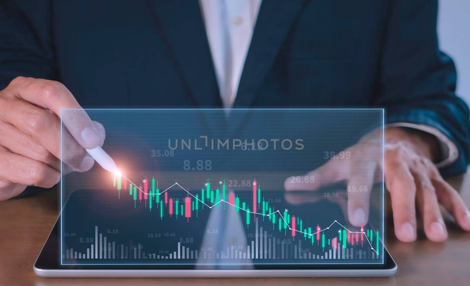 Businessman writing analyze graph for trade stock market on tablet screen. Businessman hand drawing chart graph stock of growth. Hand man uses pen to draw stock graph chart point of target success.