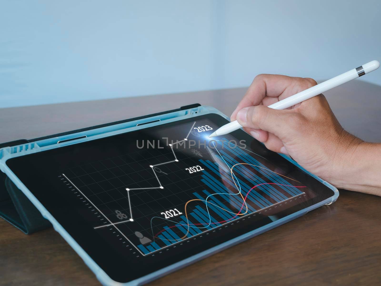 Hand of businessman use stylus pen point on tablet screen show analysis stock bar chart for target 2023. Analysts present a business plan with a graph showing the company's 2023 growth with a tablet.
