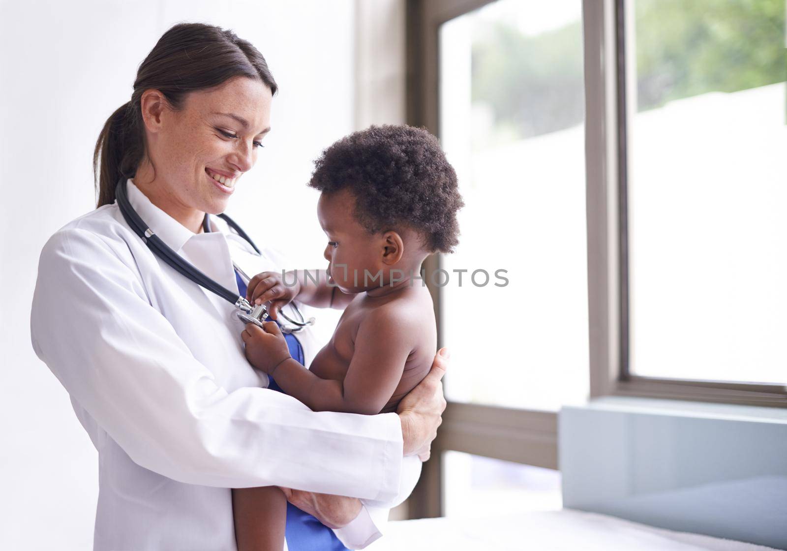 Cropped shot of a female pediatrician doing a checkup on an adorable baby boy.