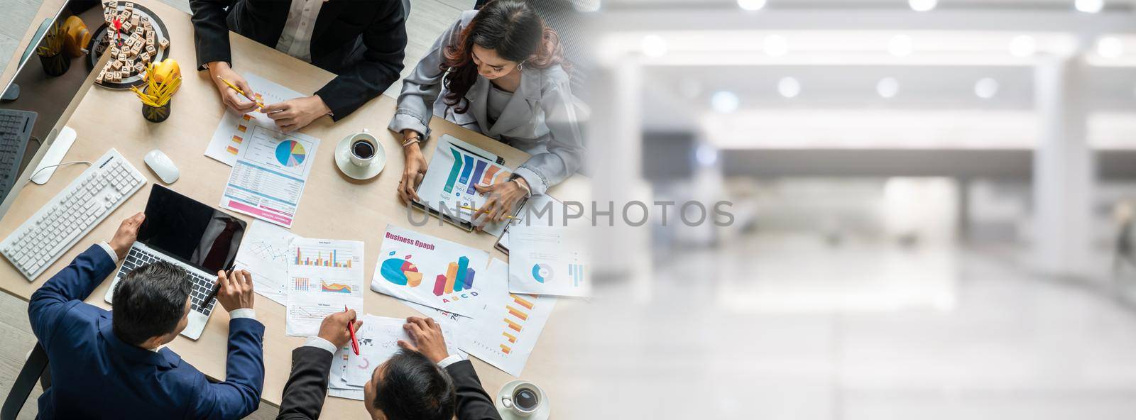 Business people group meeting shot from top widen view in office . Profession businesswomen, businessmen and office workers working in team conference with project planning document on meeting table .