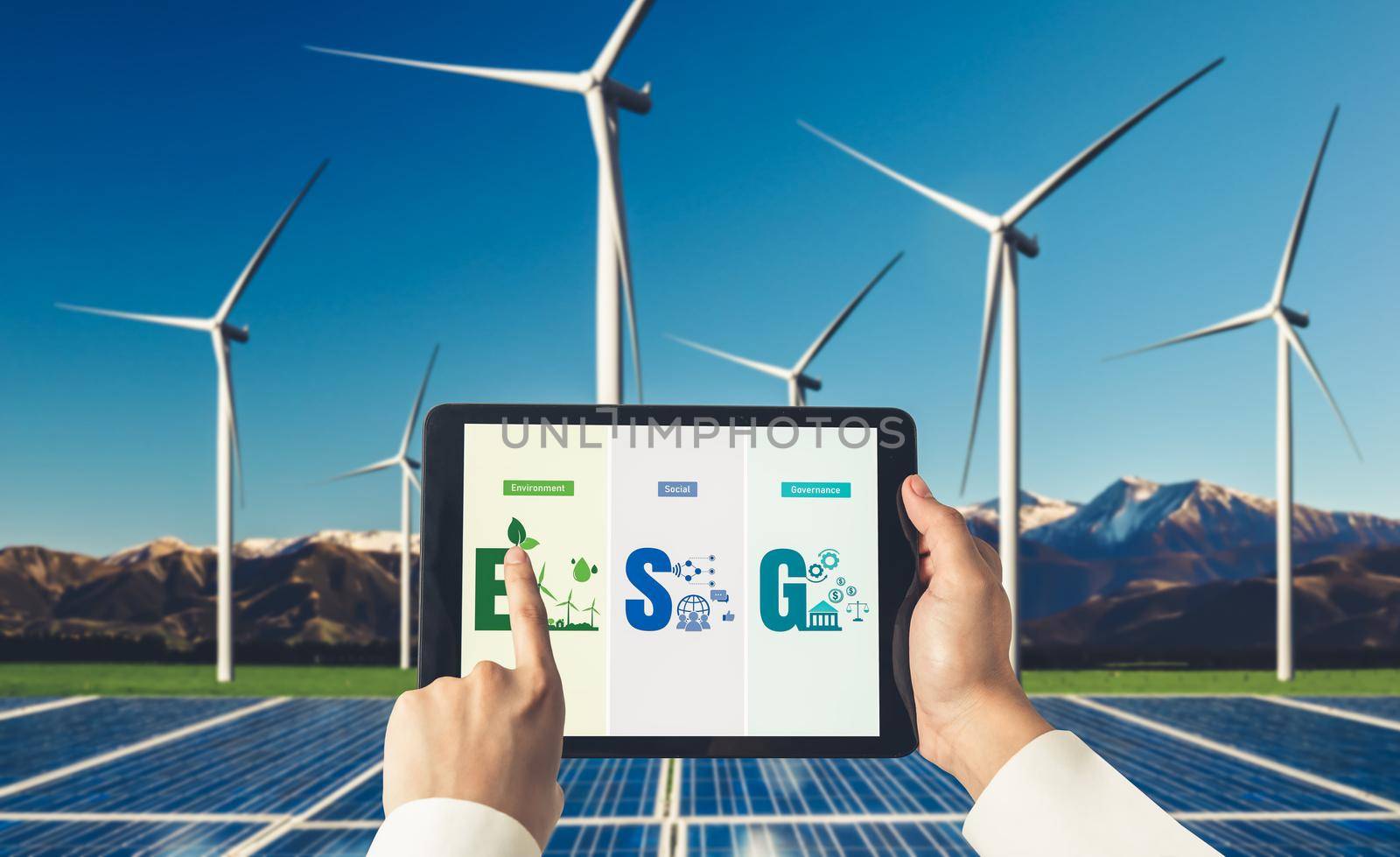 Green business transformation for environment saving and ESG business concept. Businessman using tablet to set corporate goal toward environmental friendly management and alternative clean energy use.