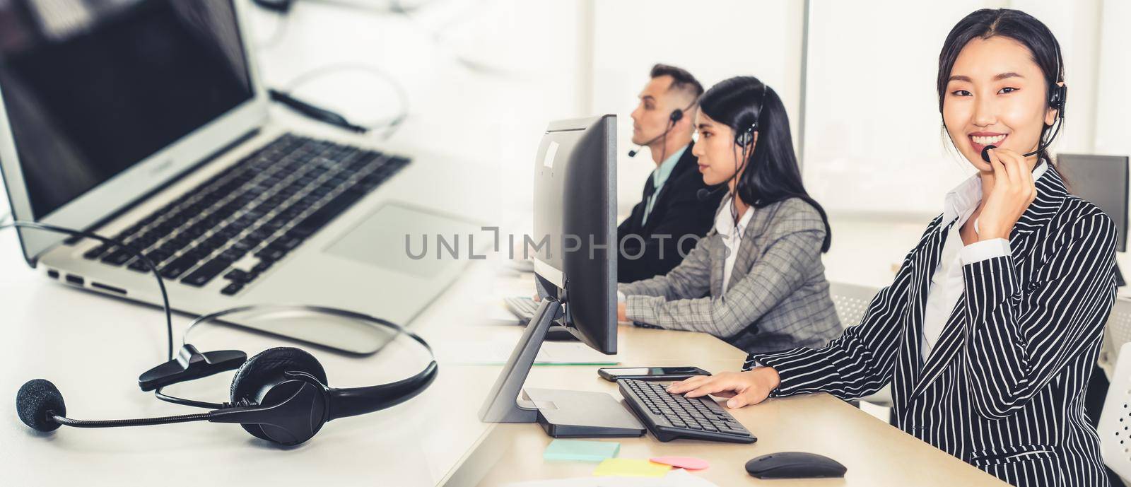 Business people wearing headset working in office broaden view by biancoblue