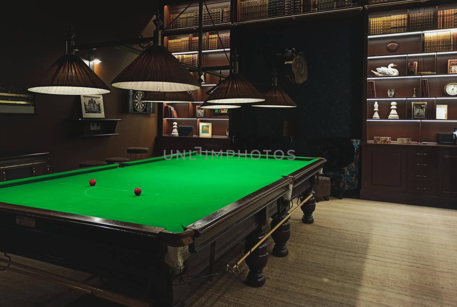 A full size snooker / billiards table in a classic style games room parlour