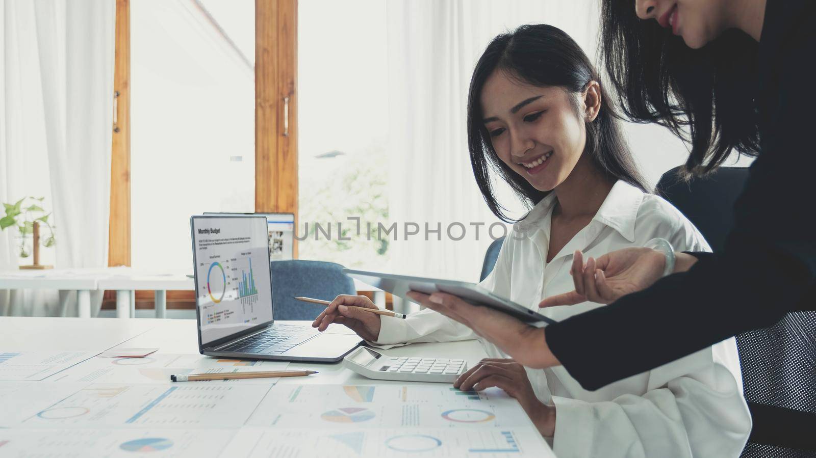 Business meeting concept.Coworkers team working new startup project at modern office.Analyze business documents, using touch tablet.Blurred background.Horizontal..