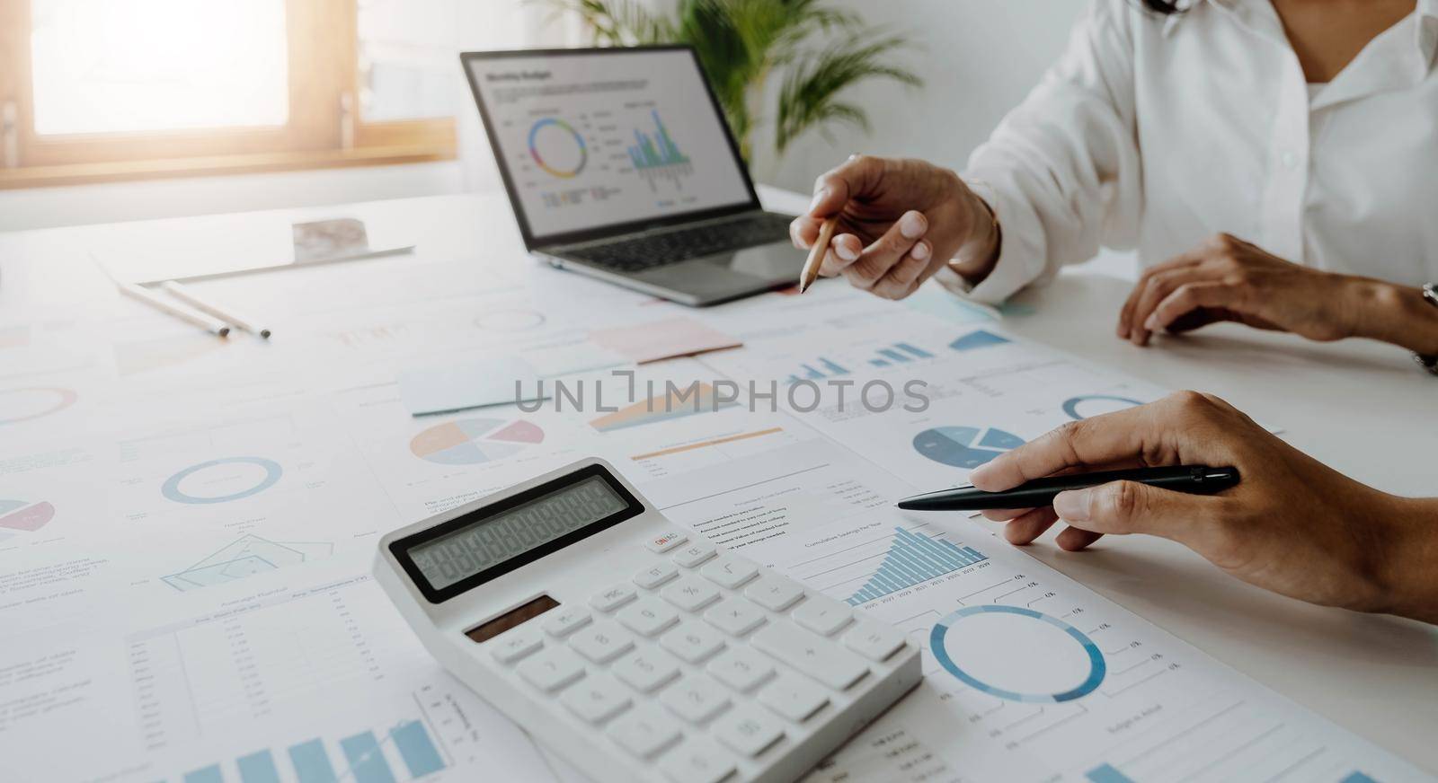 Business team analyzing income charts and graphs with modern laptop computer. Close up.Business analysis and strategy concept. by wichayada