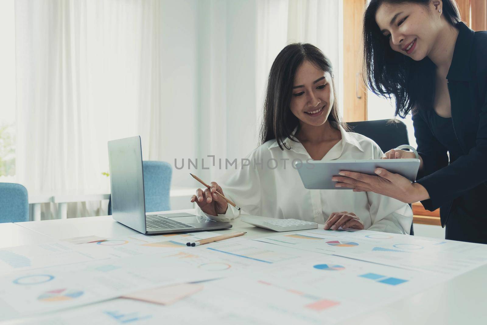 Business meeting concept.Coworkers team working new startup project at modern office.Analyze business documents, using touch tablet.Blurred background.Horizontal. by wichayada