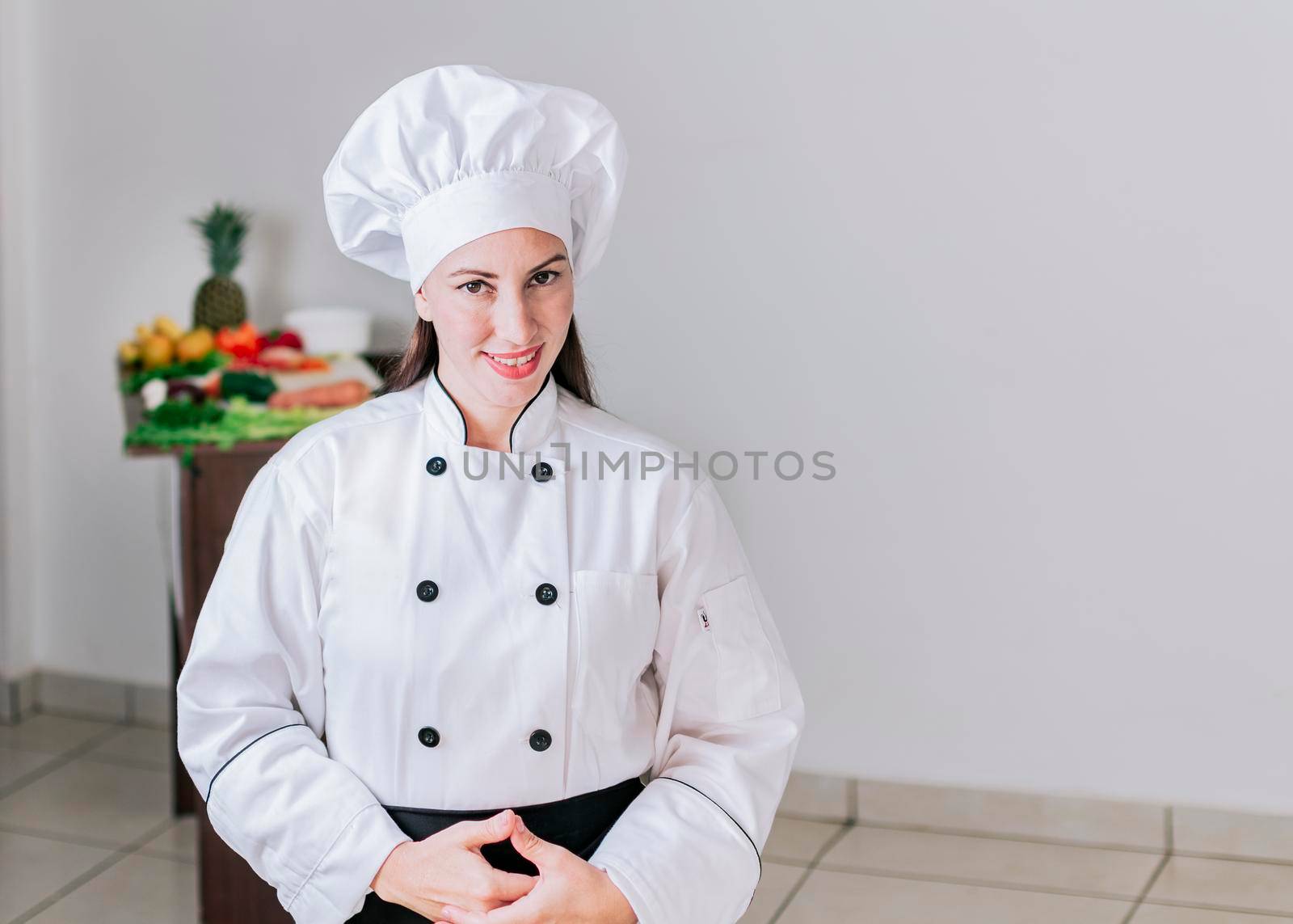 Portrait of a female nutritionist in uniform with fresh vegetables on the table, A female nutritionist with a table of vegetables, Portrait of a female chef surrounded by fresh vegetables