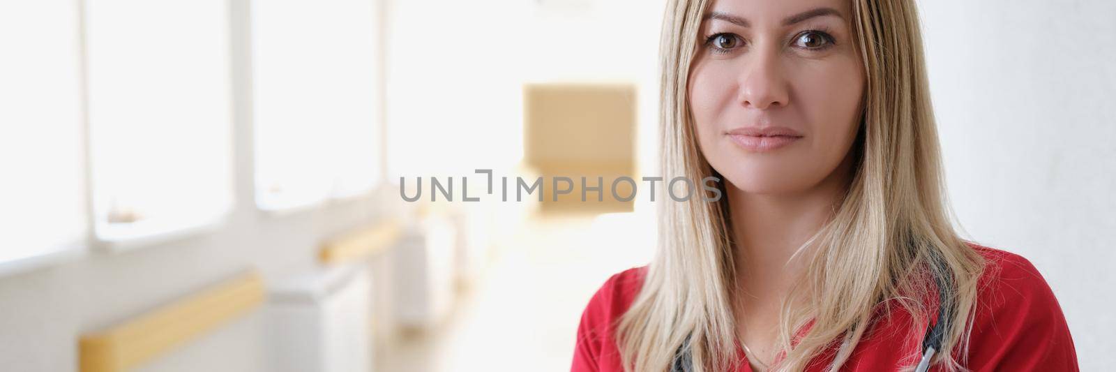 Beautiful woman doctor in the hospital corridor, close-up. Health center staff, ambulance, clinic reception