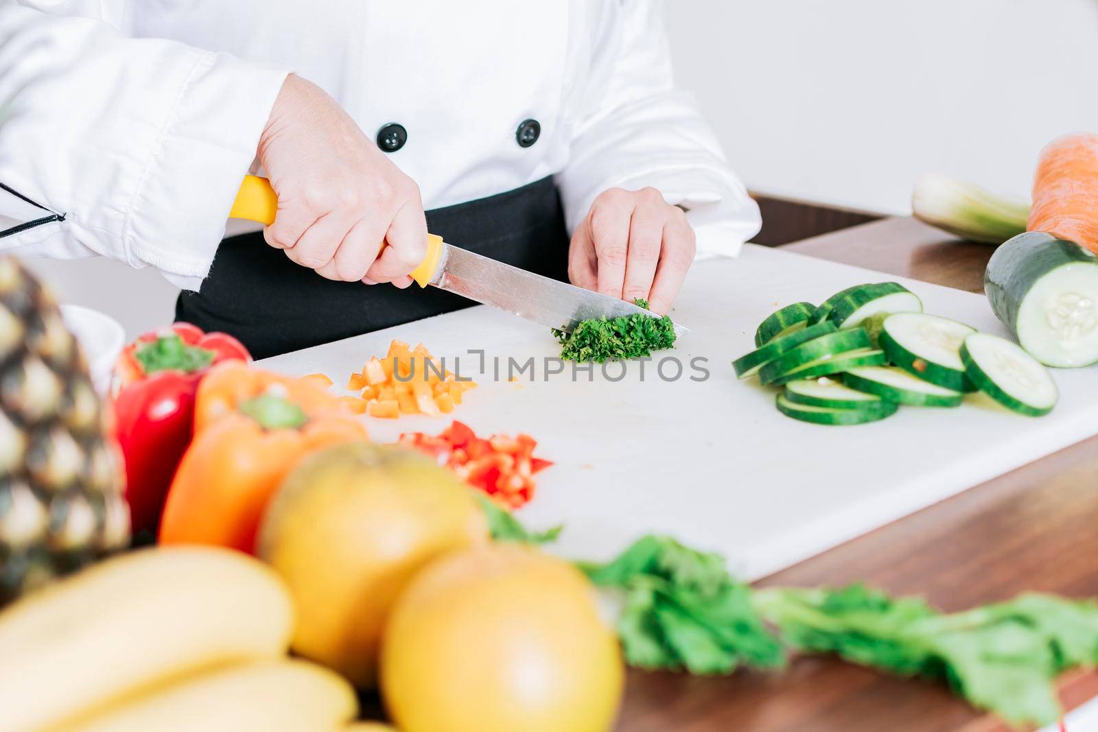 Chef hands preparing and cutting vegetables, Close up of a woman chef cutting vegetables, Hands of female chef cutting vegetables