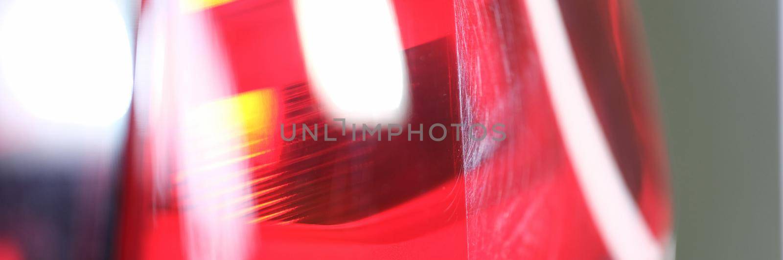 Bright red headlight of a car, close up. Light headlamp. Automotive optics polishing and repair, parts replacement