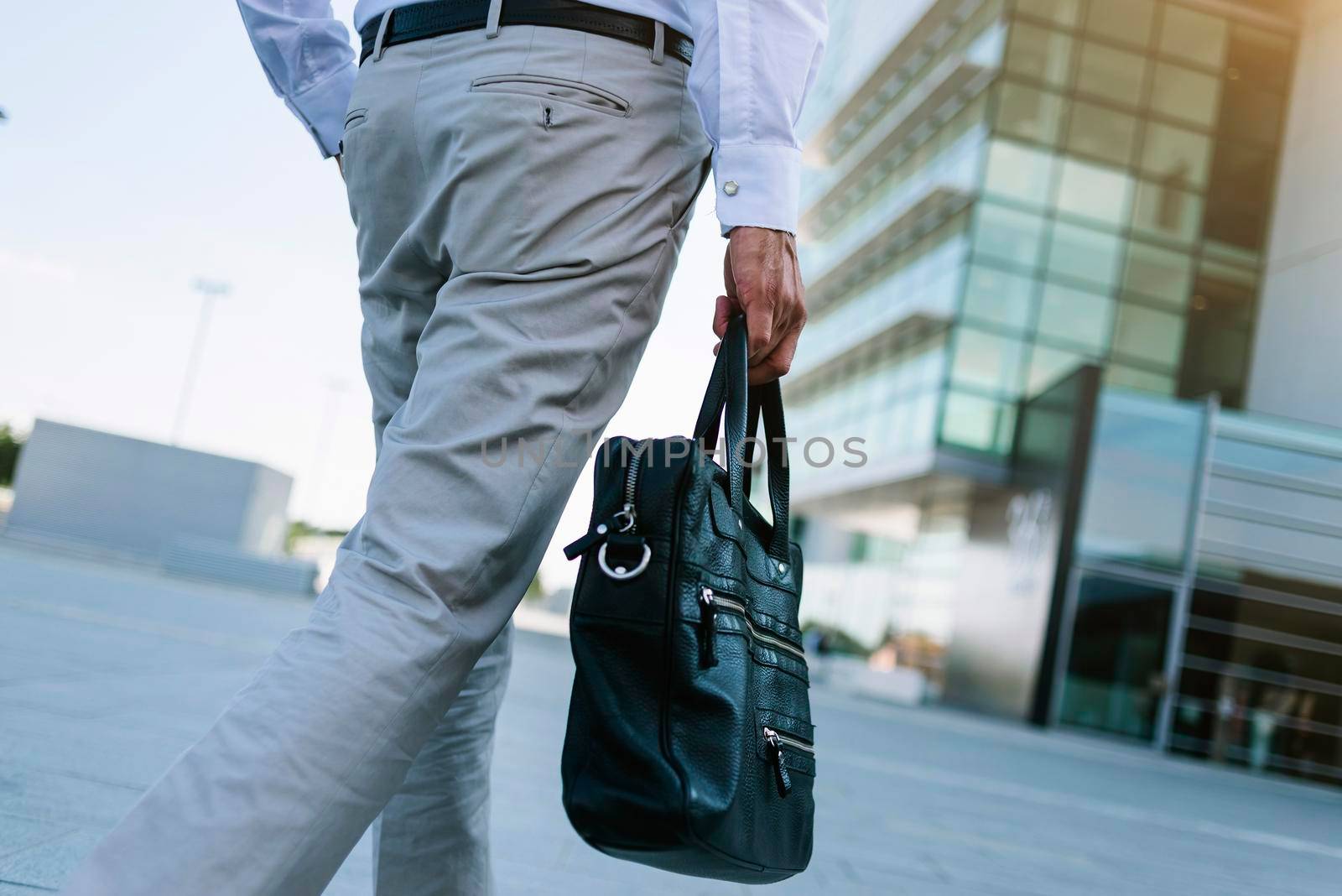 Anonymous businessman holding briefcase going to work