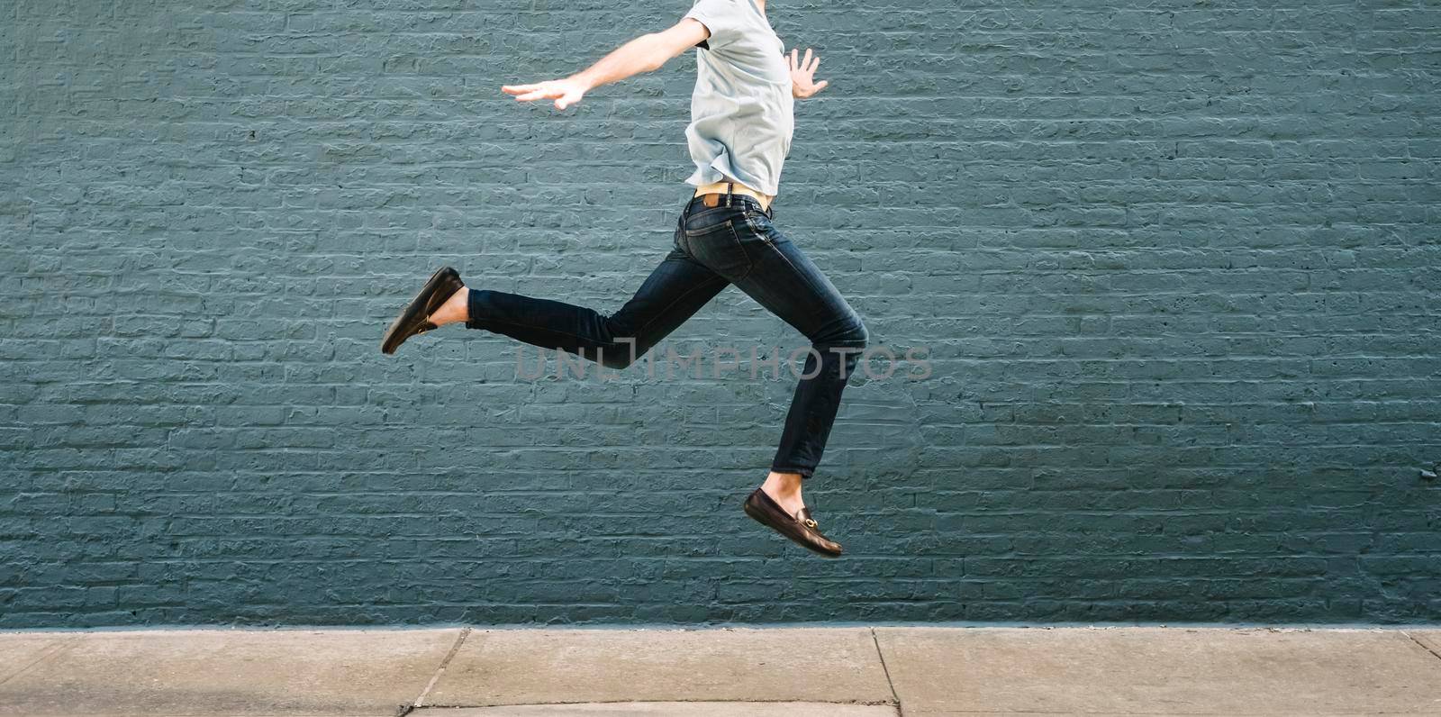 Man jumping against a wall