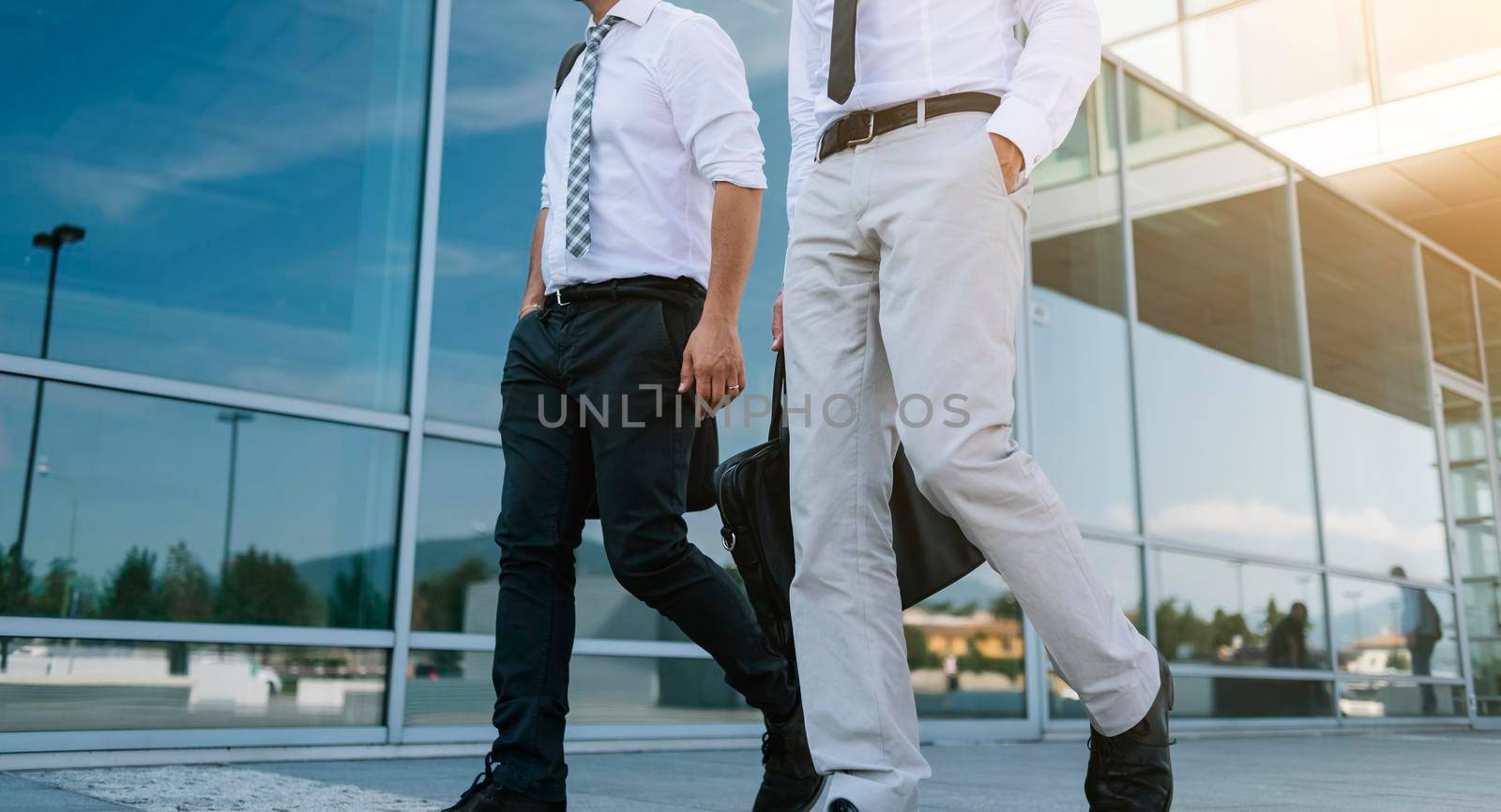 Anonymous businessmen walking together outside the company