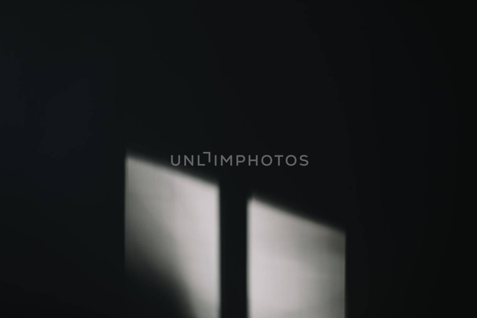Abstract background with window shadow and sunlight on a gray wall. Mockup for presentation, screensaver with reflection and window frame