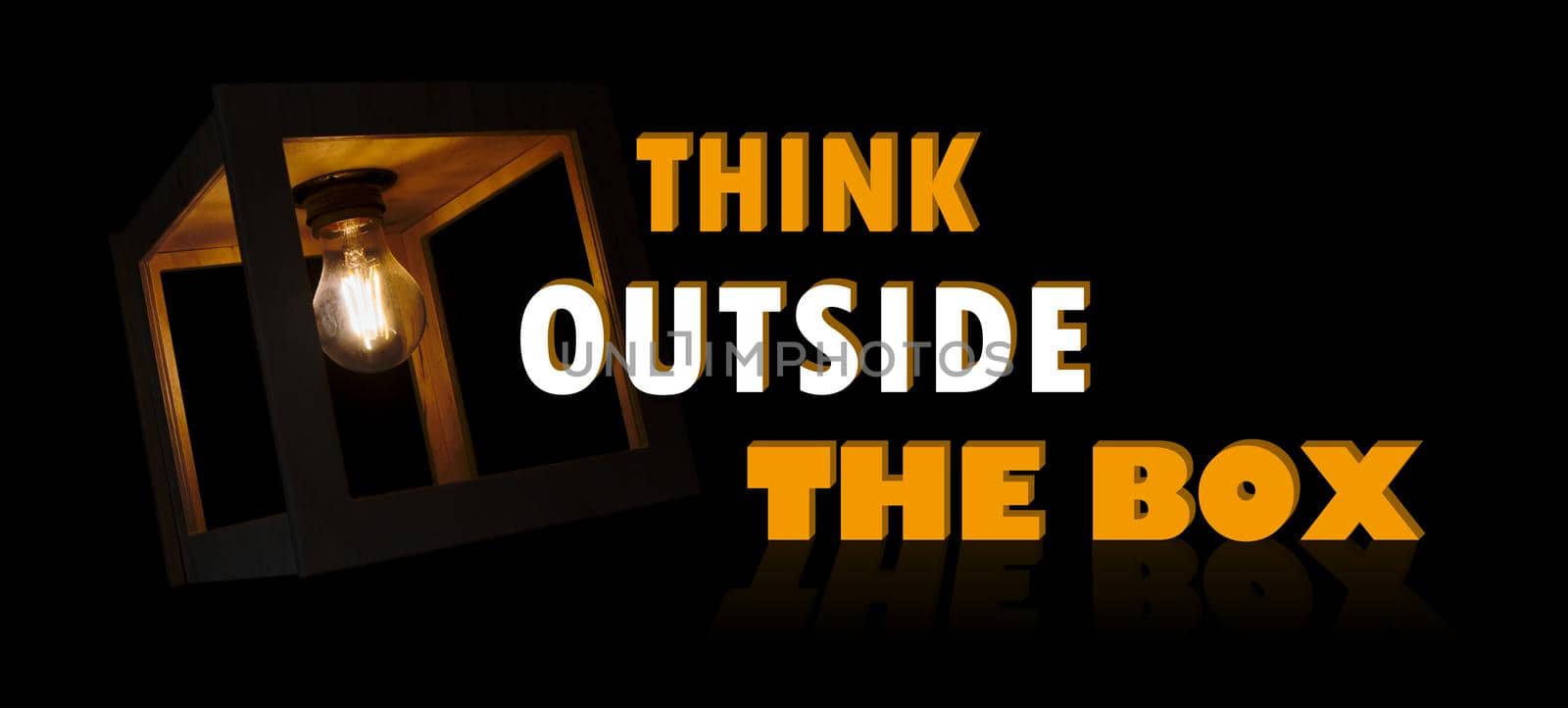Think outside the box motivational message with a light bulb shining in a wooden box frame