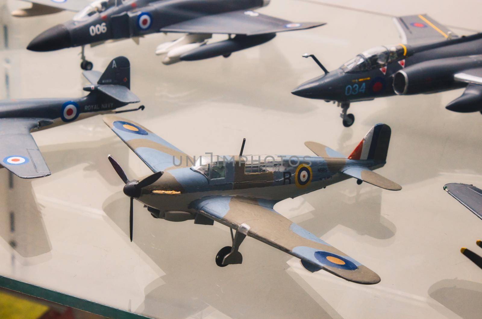 Plastic model military airplanes collection on a glass shelf