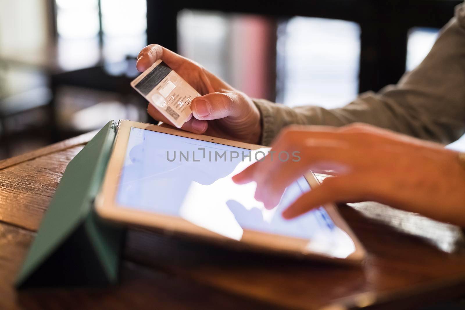 Man using a credit card with a tablet for shopping online