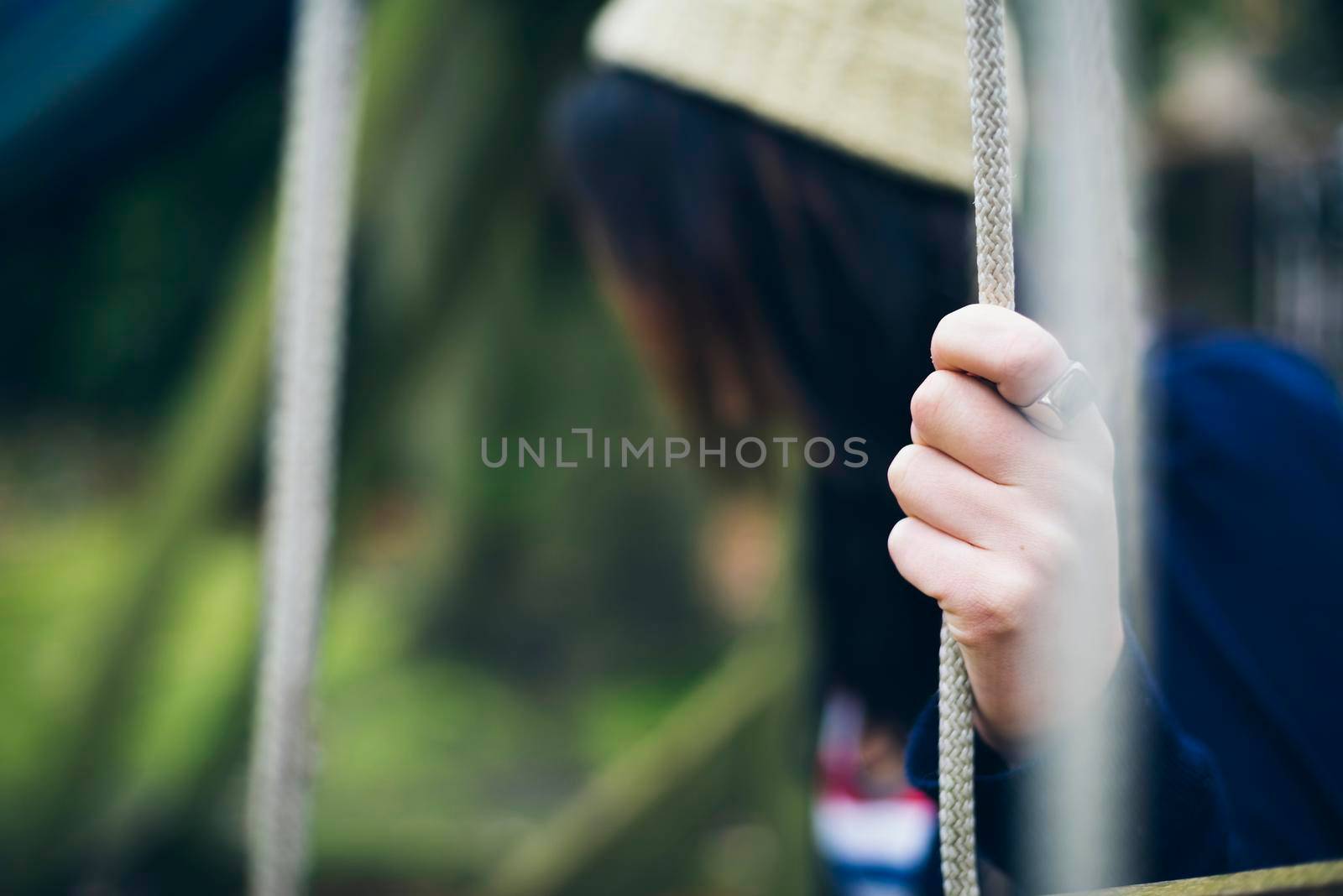 Lonely woman sitting on the swing by SimmiSimons