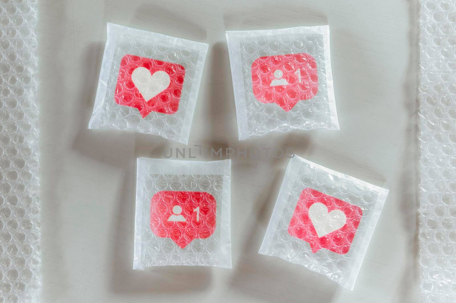 Packaging social symbols and icons with bubble wrap.