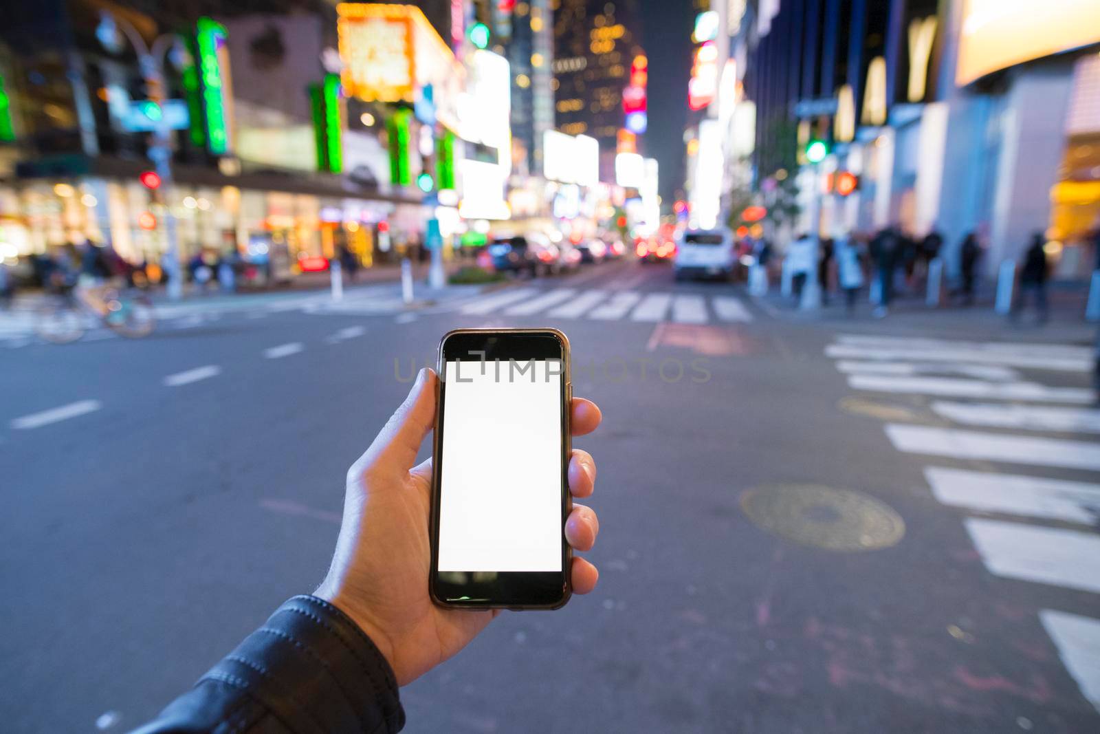 man holding a phone in Manhattan New York City.