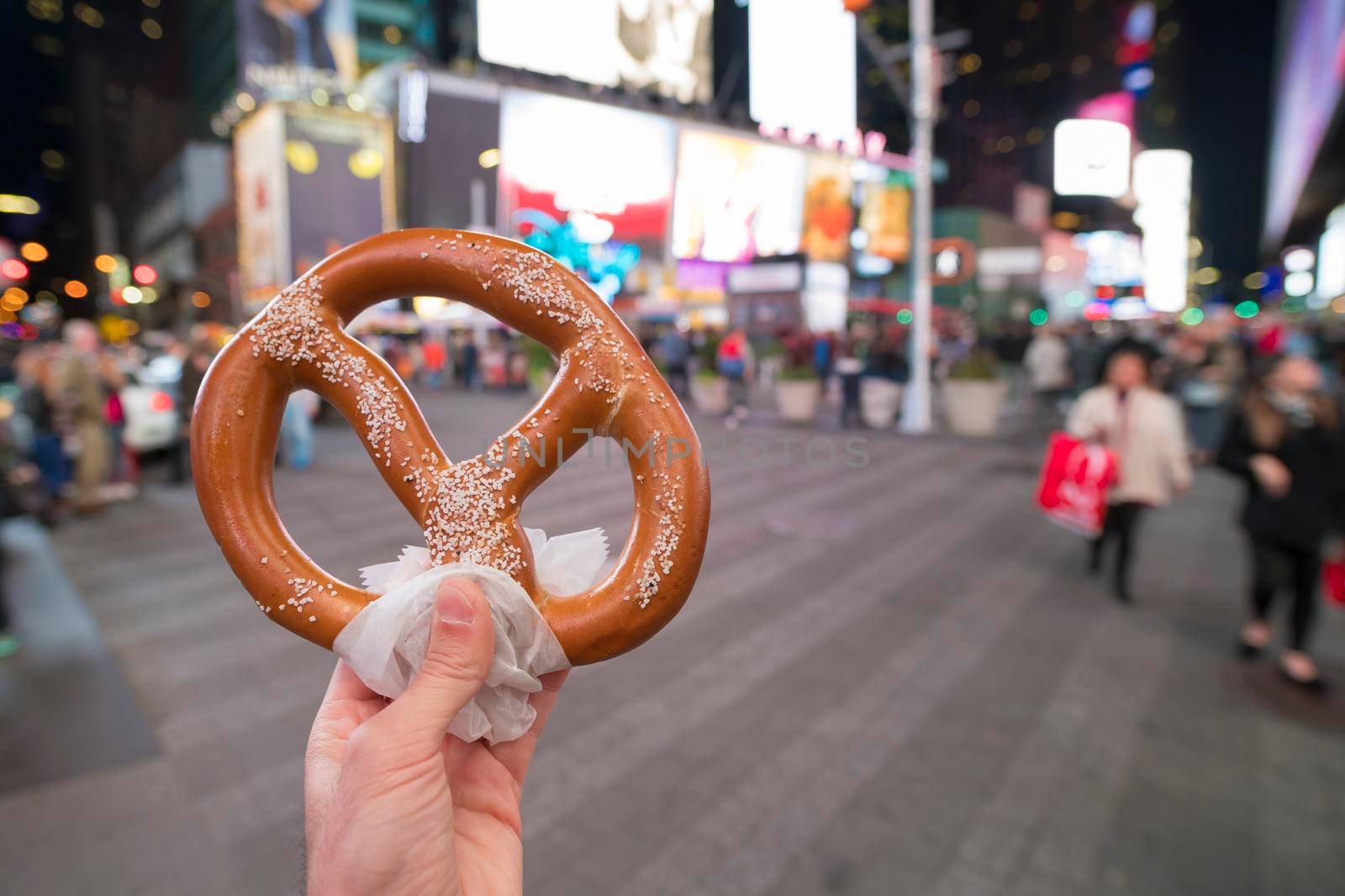 Eating Pretzel fast food in New York City.