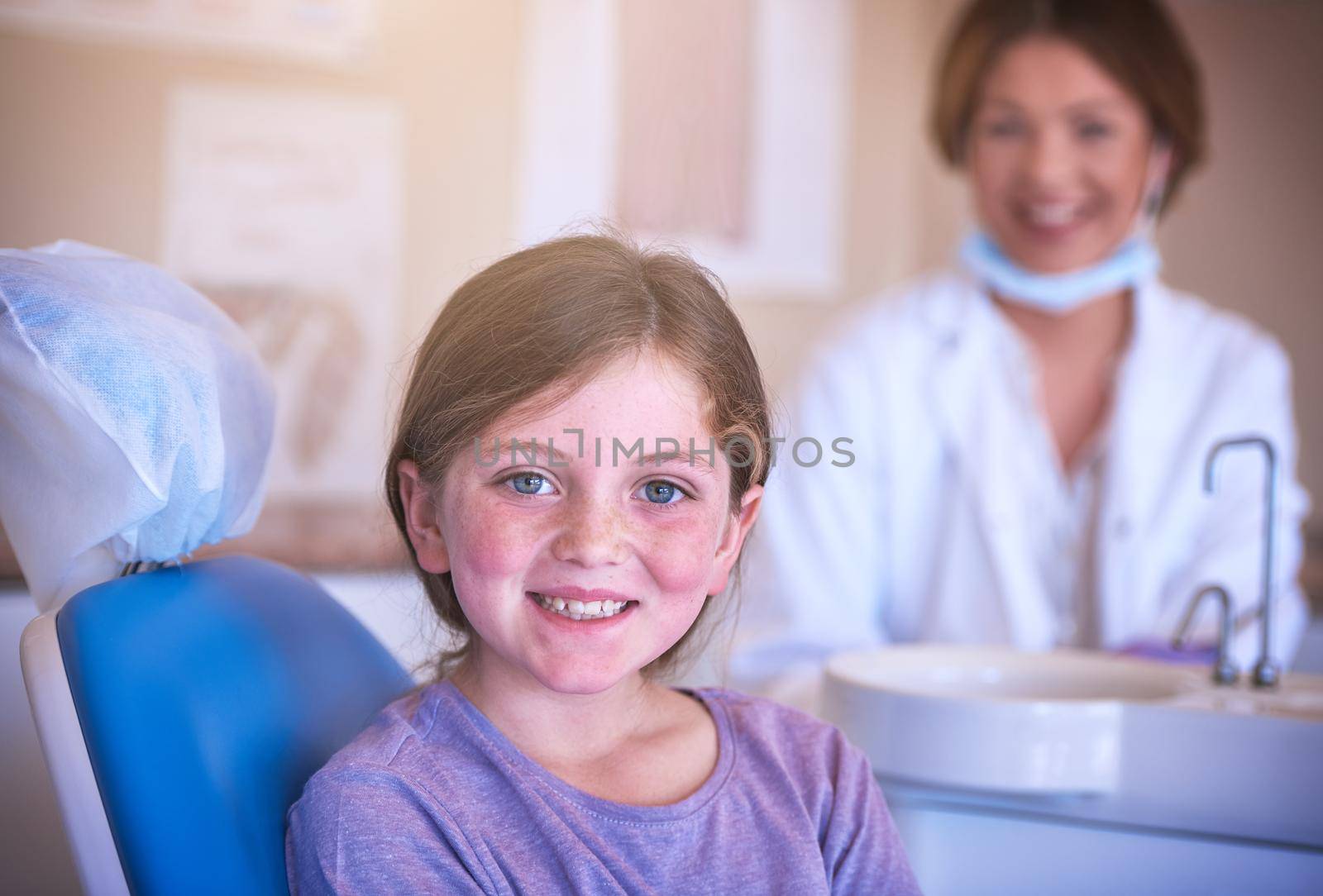 Oral health is an important part of a childs health. Shot of a little girl at the dentist for a checkup. by YuriArcurs