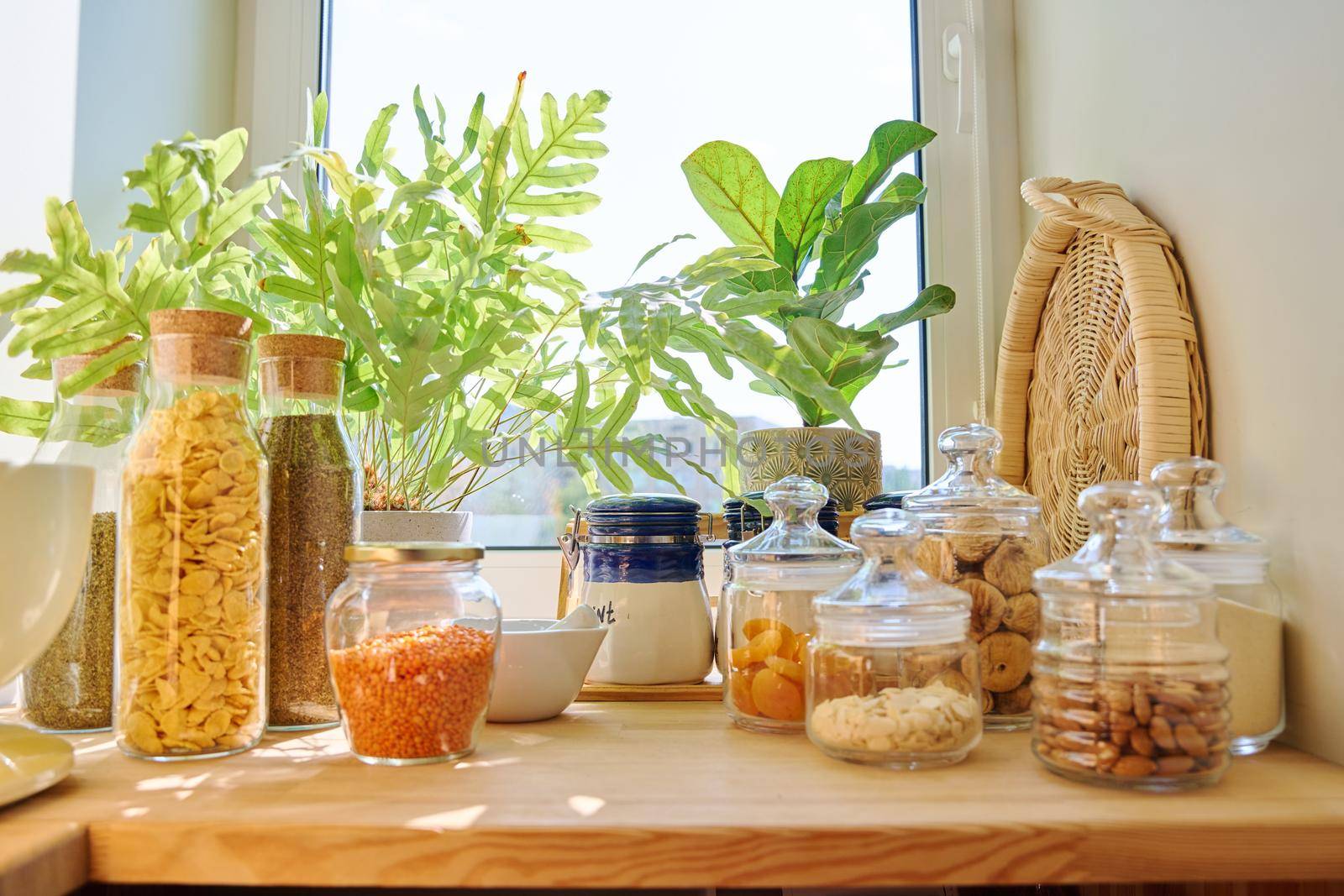 Storage of food in the kitchen in pantry. Dry fruits, figs, nuts, cereal, herbs, kitchen utensils. Cooking at home, household concept