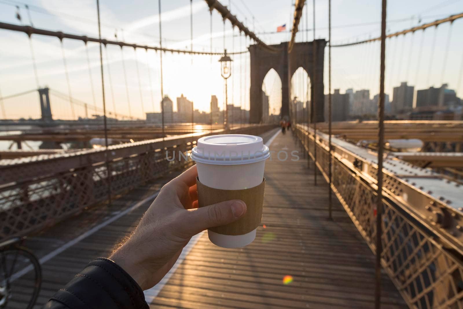 Man holding a coffee cup in New York City by SimmiSimons