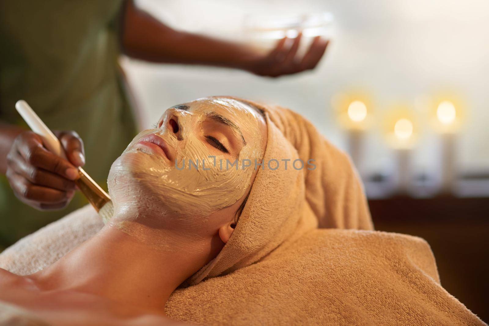 Only the best for perfect skin. Shot of a young woman receiving a beauty treatment in a spa. by YuriArcurs