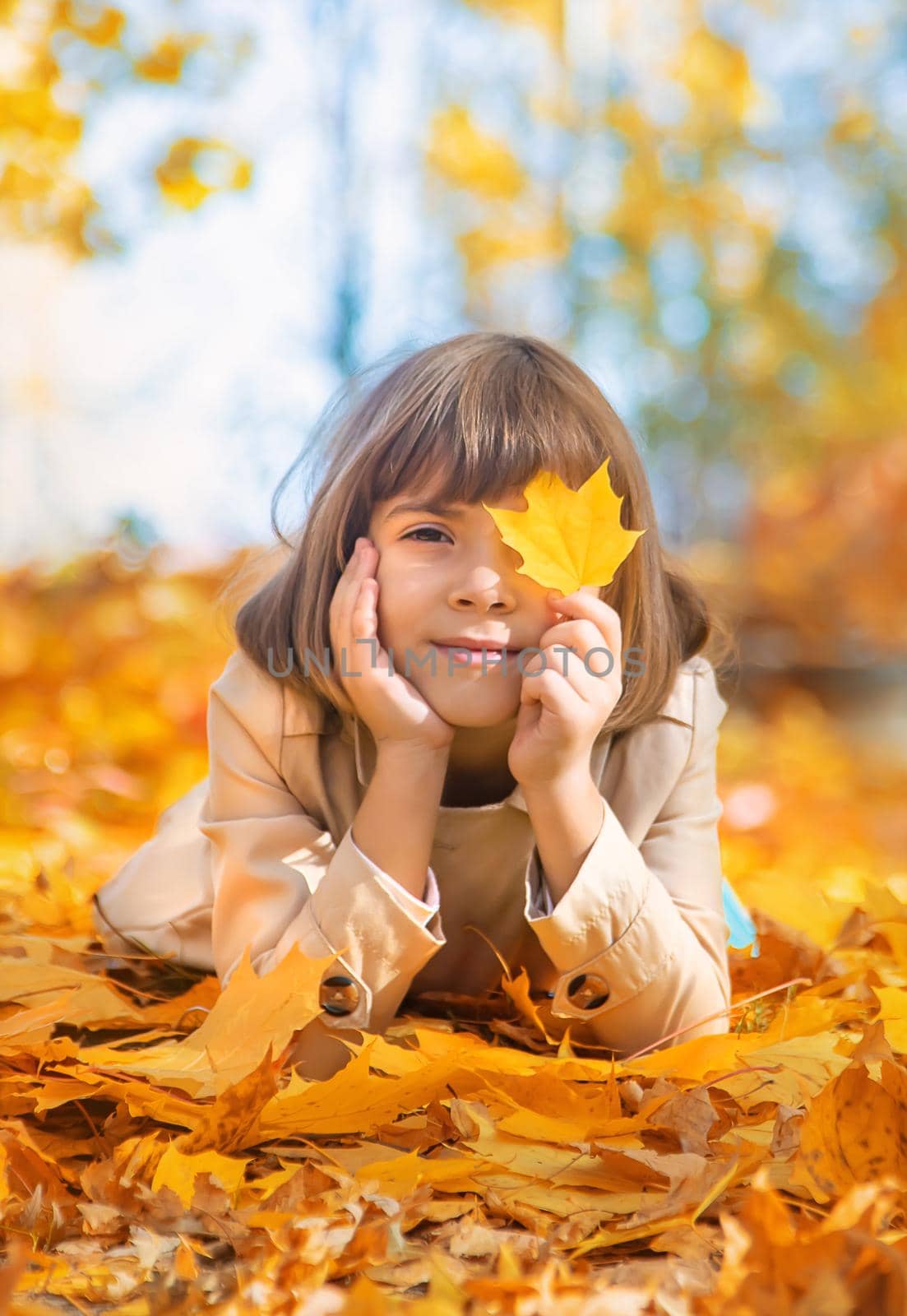 Children in the park with autumn leaves. Selective focus.