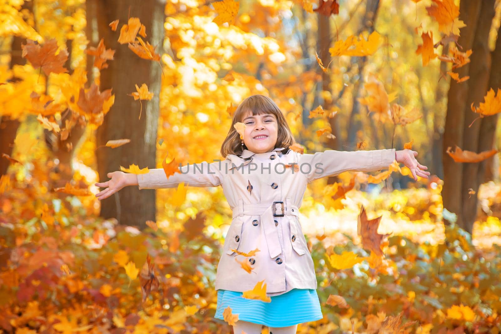 Children in the park with autumn leaves. Selective focus.