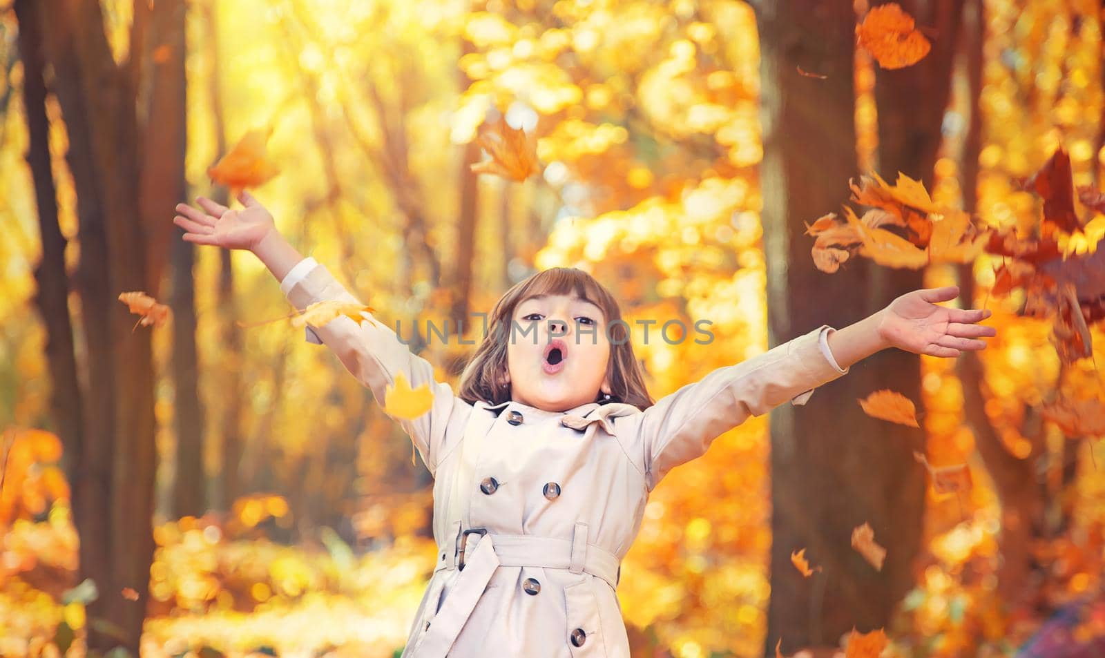 Children in the park with autumn leaves. Selective focus.