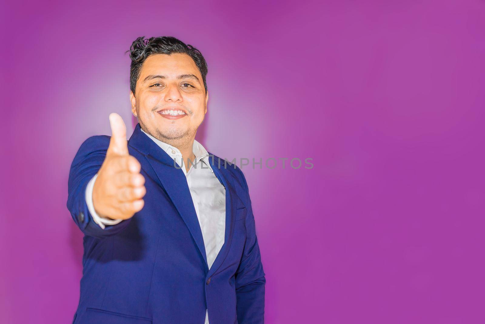 Nicaraguan man with blue suit on purple background with thumb up by cfalvarez