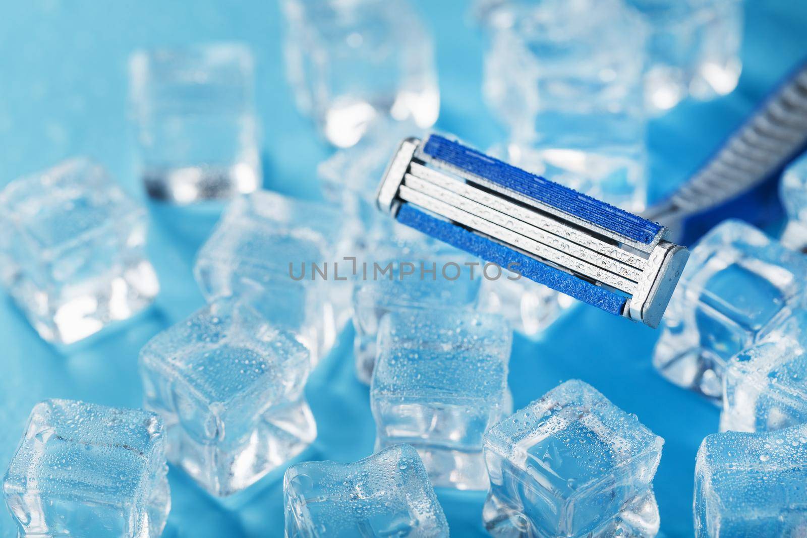 Refreshing shaving machines for the face against the background of frosty ice cubes by AlexGrec