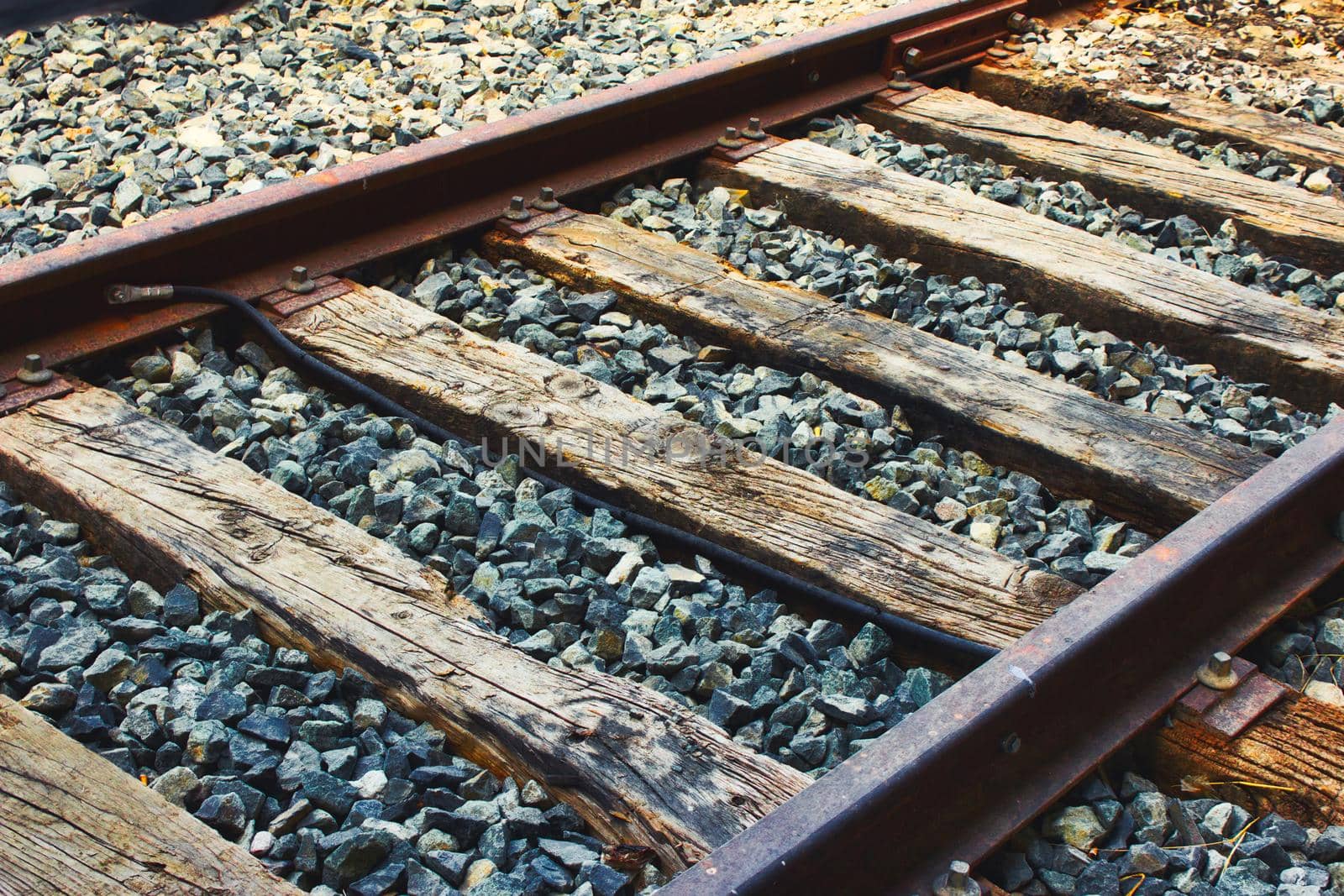 Close-up of train tracks, steel rails and wooden sleepers