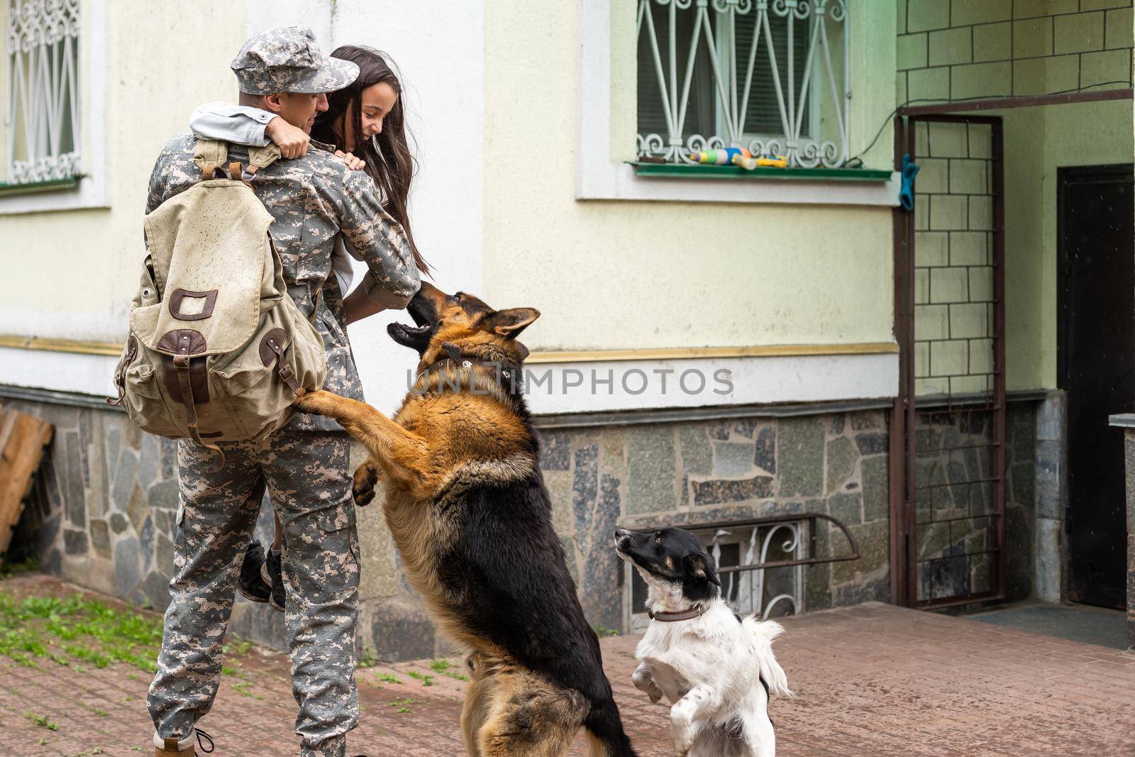 military father meeting with daughter and dogs.