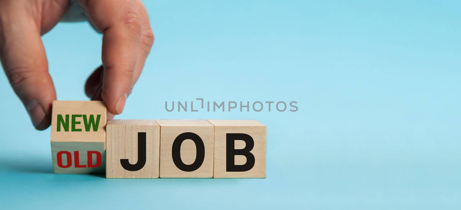 Old Job and New Job, Career change conceptual image. Hand is turning wooden cubes and changes the expression old job to new job