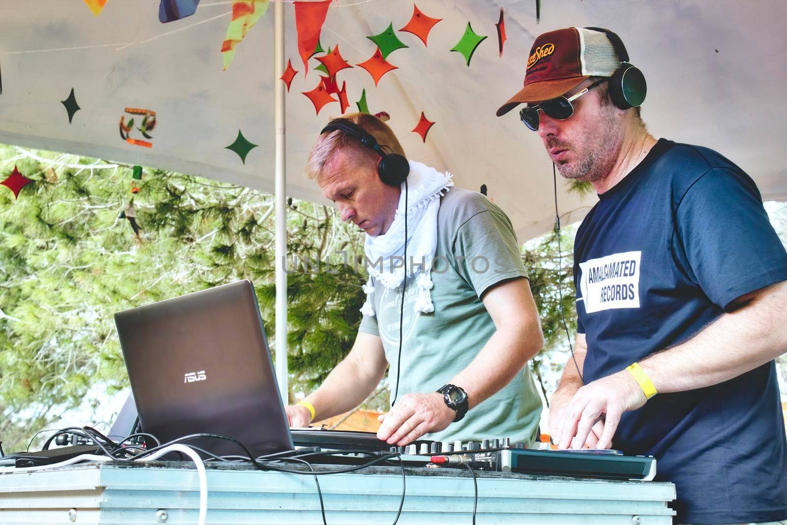 TaQali, Malta - Sept 23 2017: A couple of male DJs playing music under a tent at a summer festival