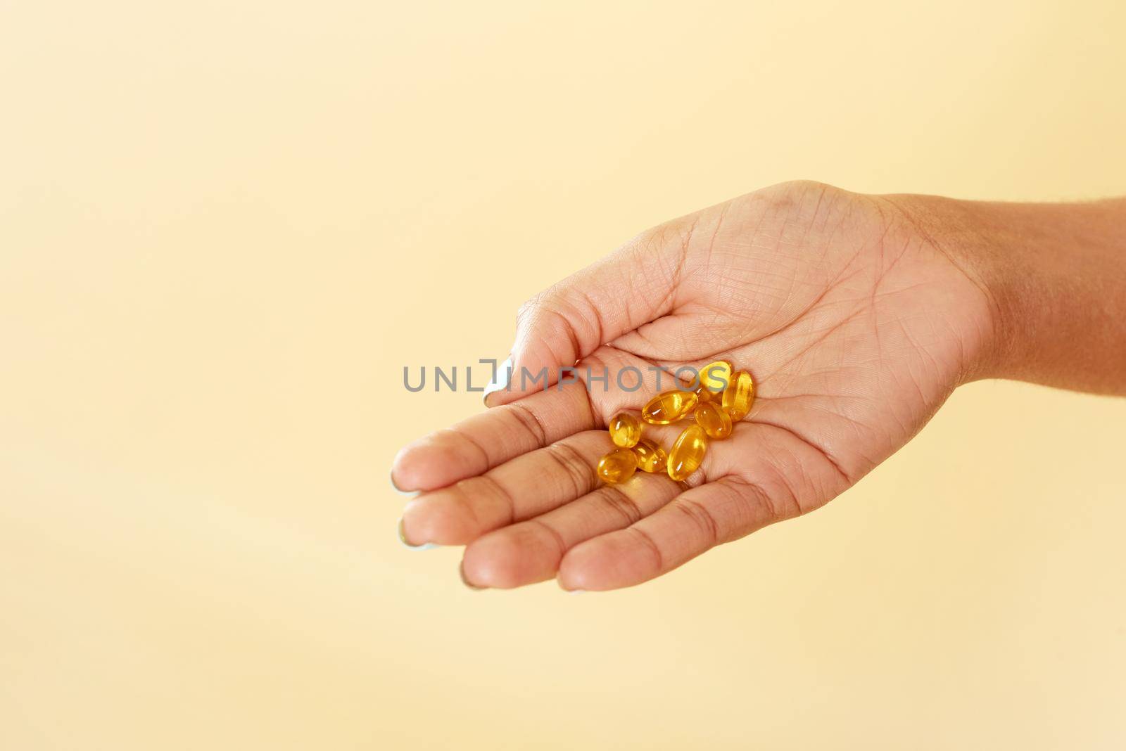 Black woman holding vitamin c pills. Smiling african lady using vitamins for healthy immunity or beauty. close hand.